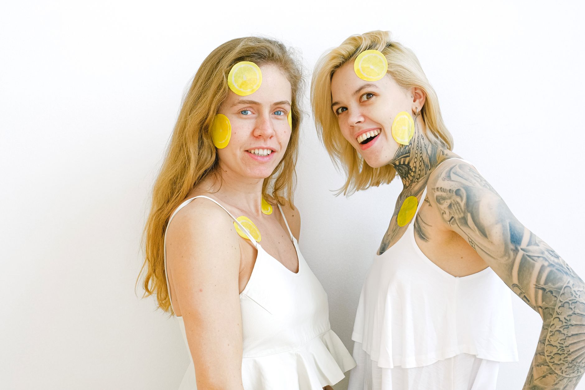 A colorful vibrator surrounded by citrus slices on a yellow background, symbolizing pleasure and fresh intimacy
