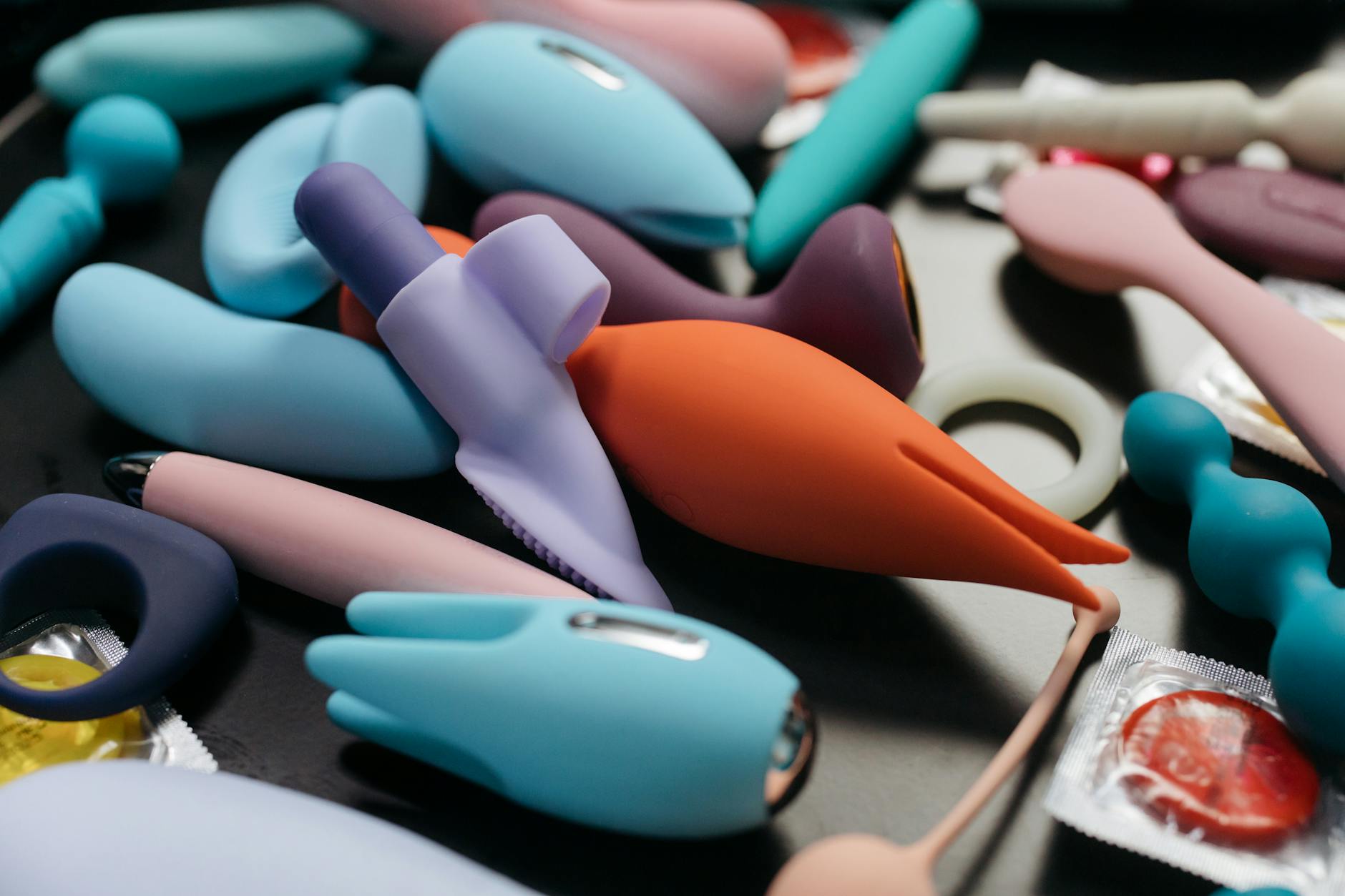 A hand holding a vibrator against a minimalist background, symbolizing intentional self-pleasure and relaxation